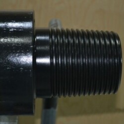 Close-up view of a metal cylindrical component with precision threading, highlighting its polished surface and detailed engineering.